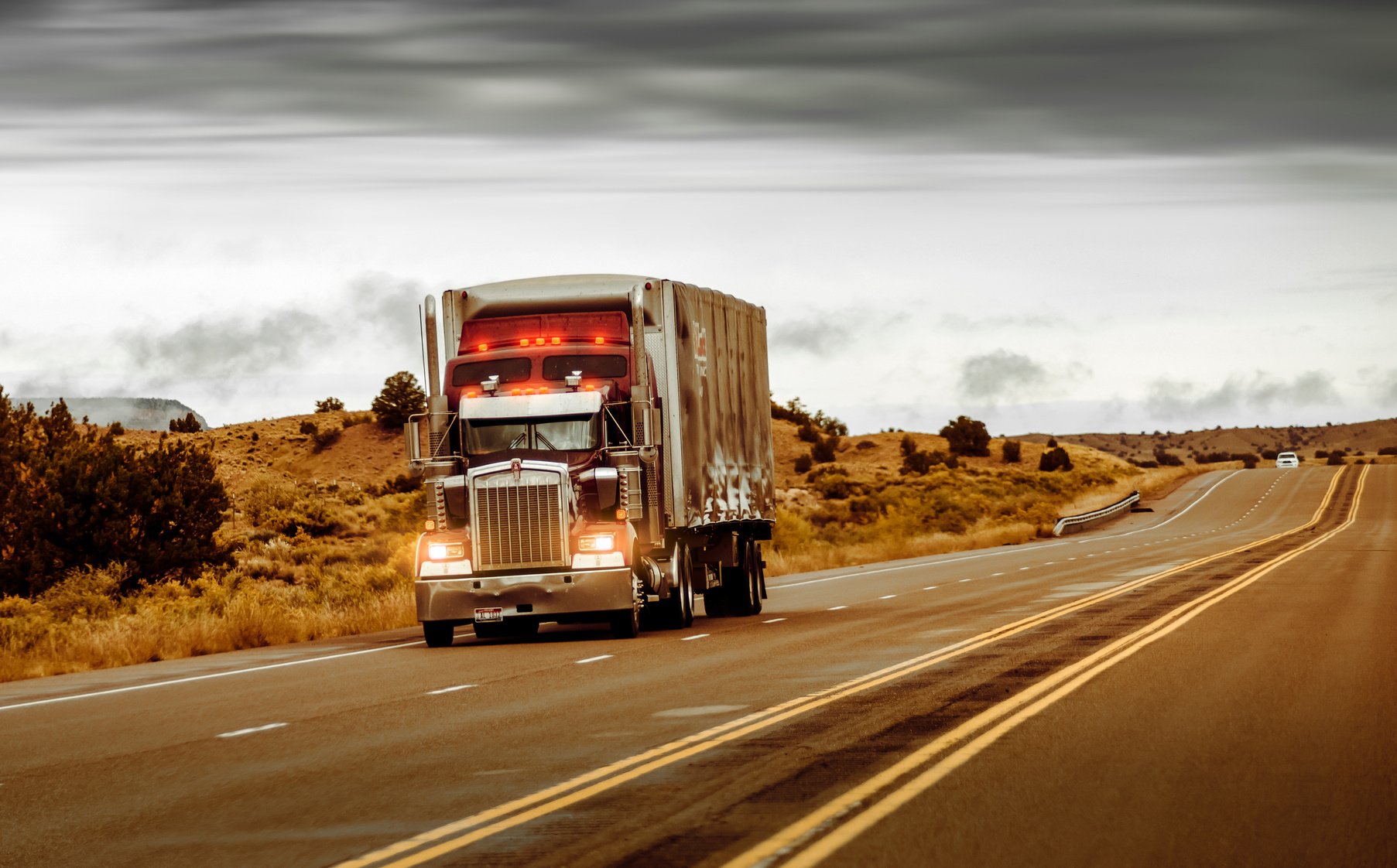 Red and Silver Truck on Asphalt Road